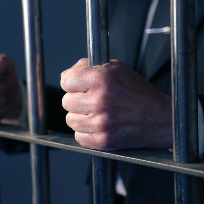 Hand on jail cell bars